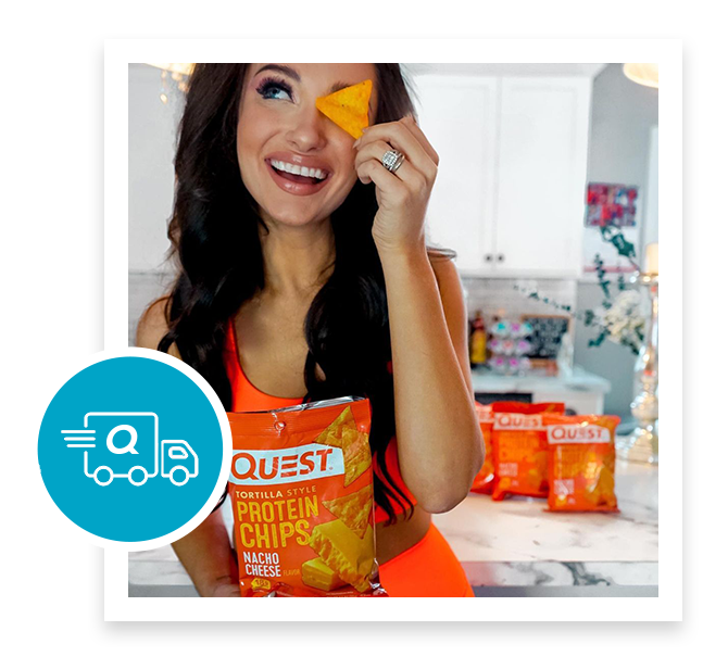 woman looking at quest tortilla protein chips and smiling
