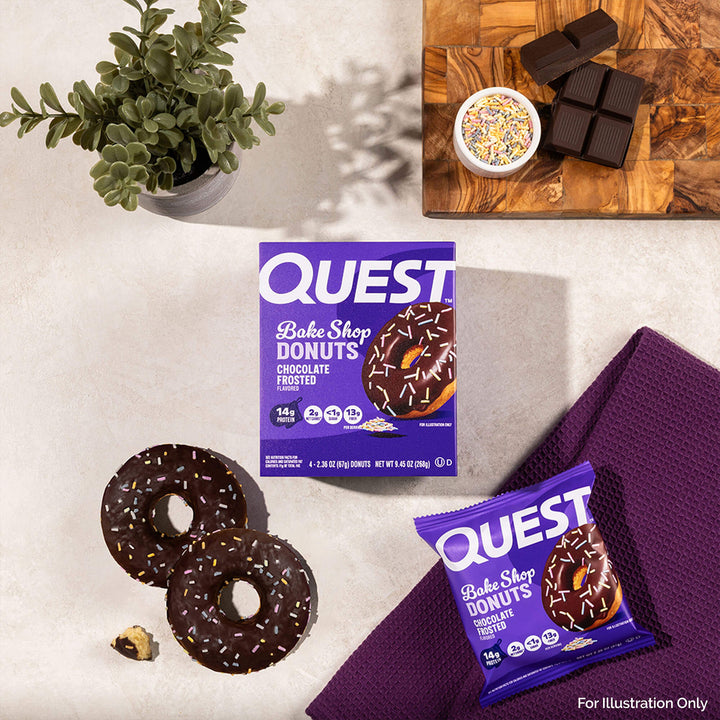 Quest Bake Shop Donuts packaging with donuts and a plant on a light surface