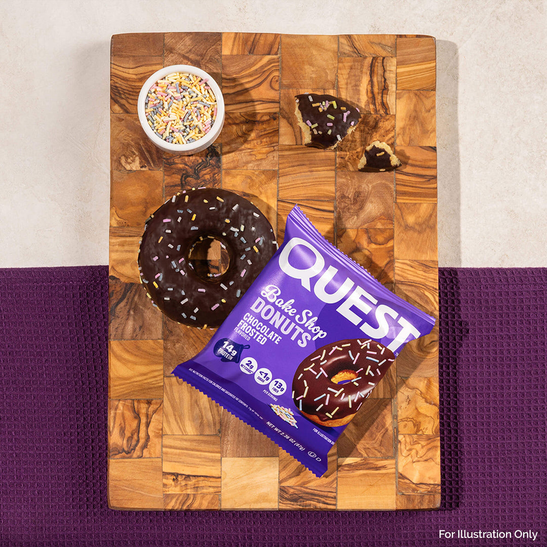 Quest Bake Shop Chocolate Donuts package on a wooden cutting board with donuts and sprinkles.