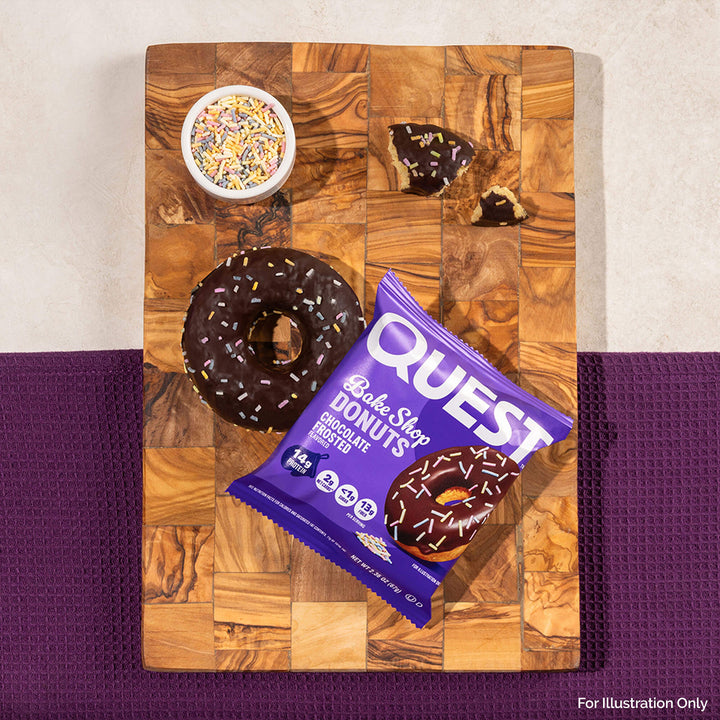 Quest Bake Shop Chocolate Donuts package on a wooden cutting board with donuts and sprinkles.