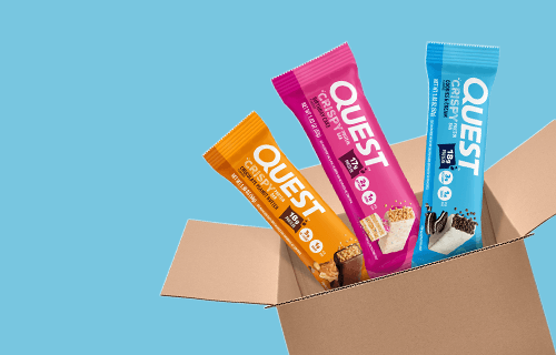 Quest Protein Chips Variety Pack featuring assorted tortilla-style protein chip flavors in an open box, including Nacho Cheese, Ranch, Chili Lime, and Loaded Taco.