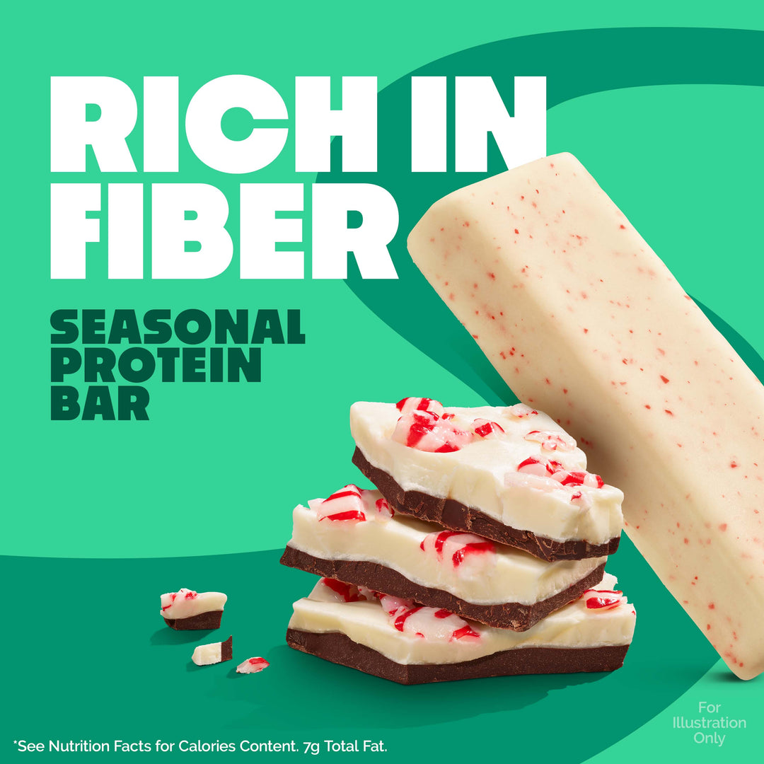 Protein bar with peppermint candy pieces on a green background, labeled 'Rich in Fiber'.