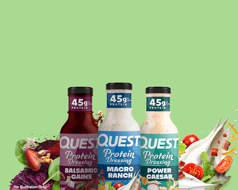 Three Quest Protein Dressing bottles on a green background. Varieties include Balsamic Gains, Macro Ranch, and Power Caesar, each with 45g protein.