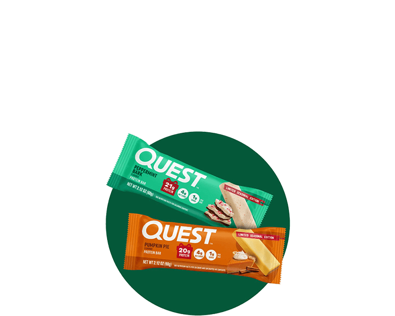 Two Quest protein bars, peppermint bark and pumpkin pie flavors, are angled against a dark background. Both are labeled "Limited Seasonal Edition."