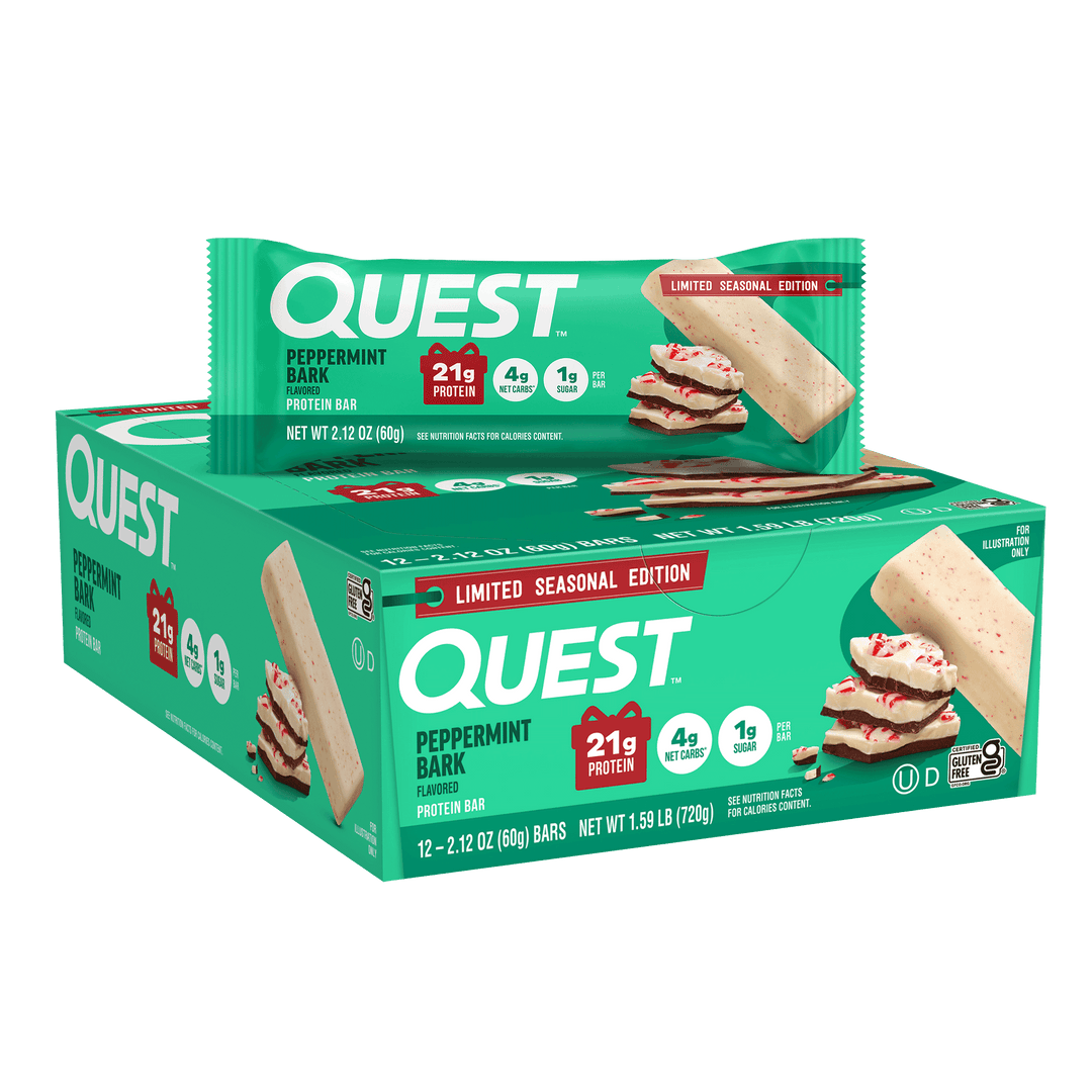 A box of Quest Peppermint Bark flavored protein bars with a single bar wrapped in branded green packaging placed on top