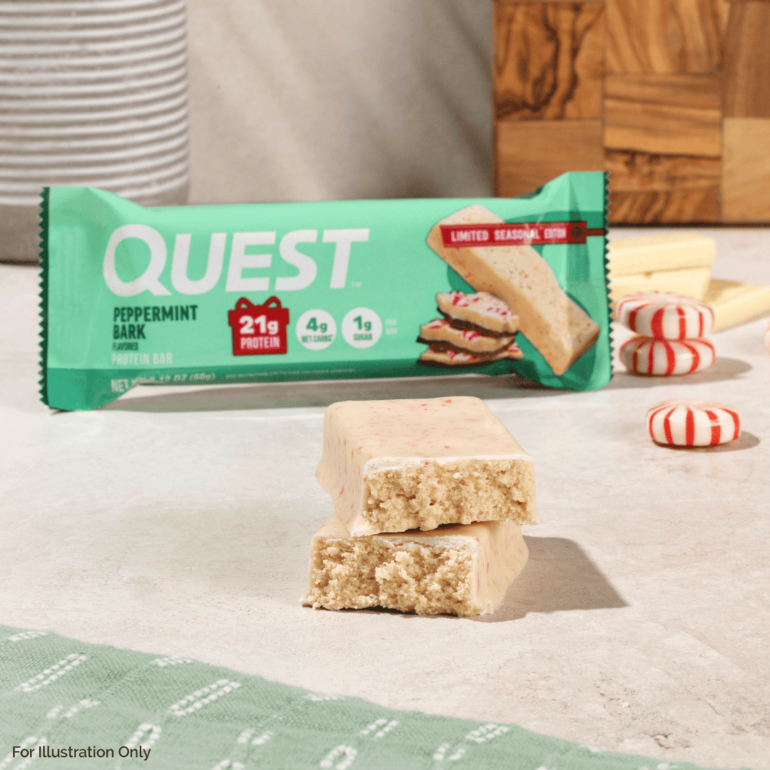Quest Peppermint Bark protein bar with packaging on a light surface