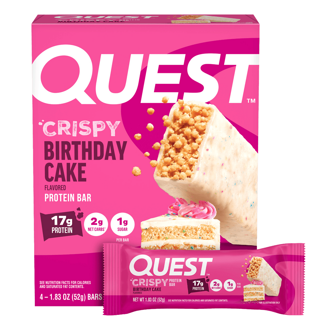 Quest Crispy Birthday Cake flavored protein bar packaging on a pink background