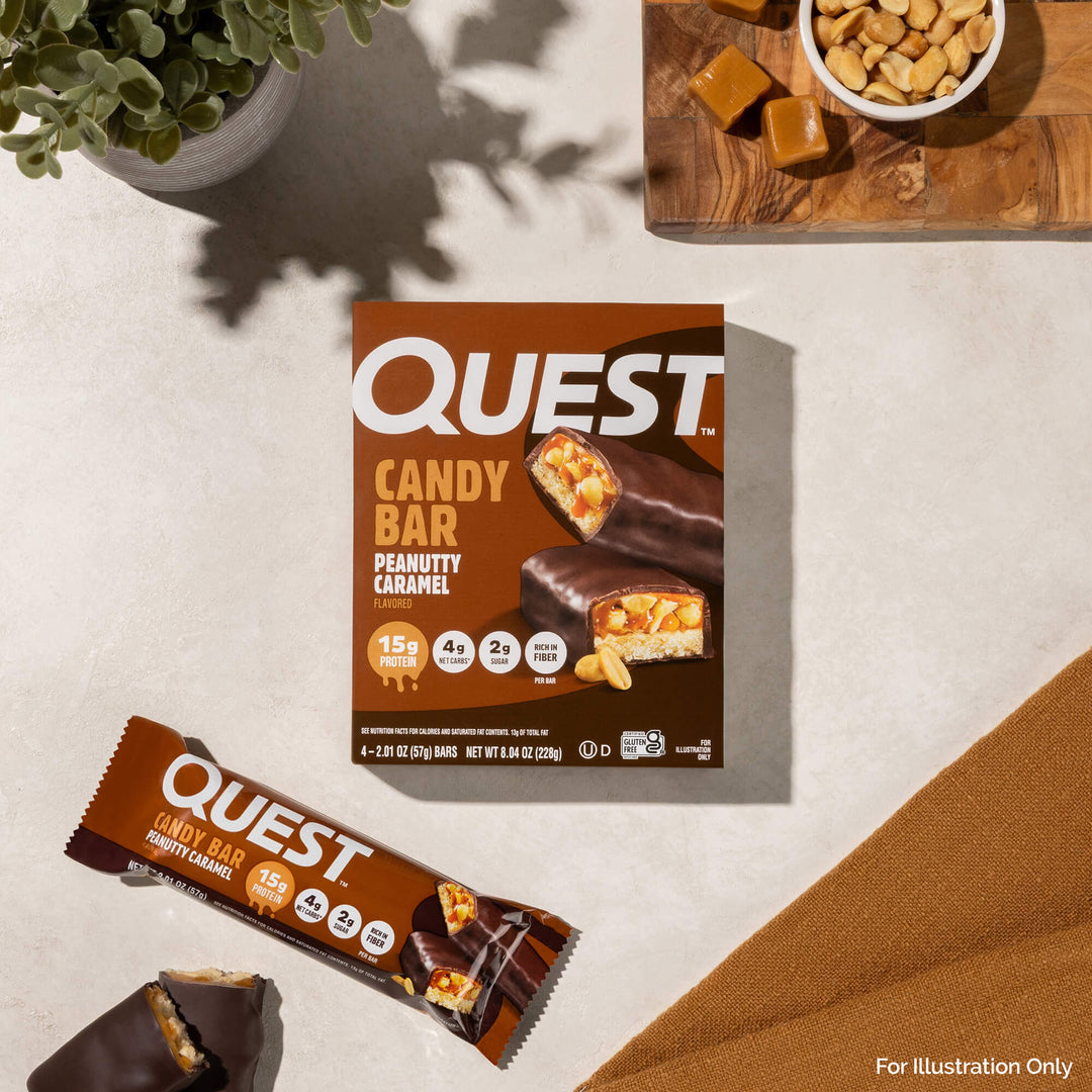 Quest Candy Bar packaging and a single bar on a neutral background with a plant and bowl of candy bars.