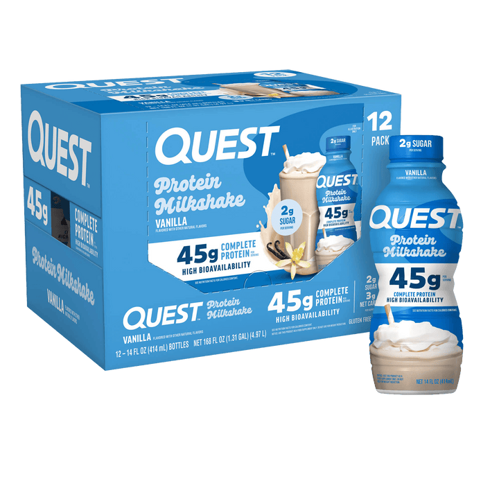 A blue box of Quest Protein Milkshake Vanilla, shown with two individual bottles and two milkshake cups in front on a plain white background.