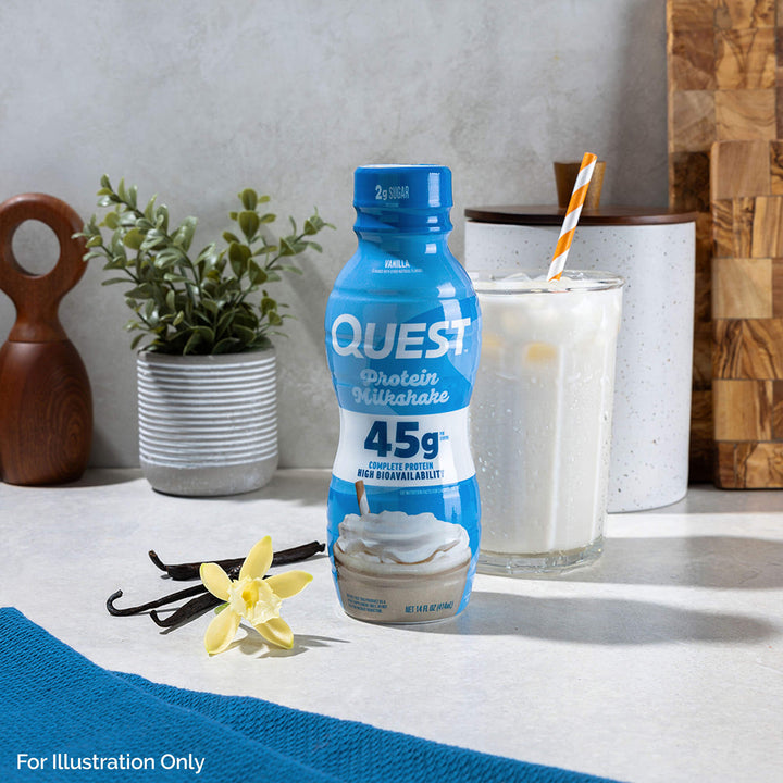 Vanilla 45g Protein Milkshake with straws in a glass of cold drink and vanilla bean on the kitchen table