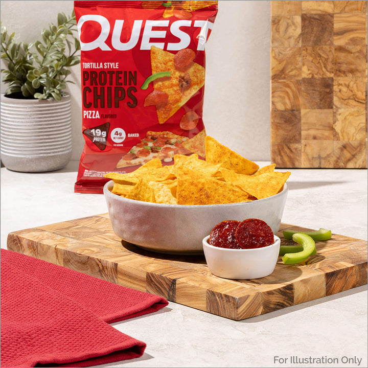 Quest tortilla style protein chips in a bowl with packaging on a wooden cutting board.