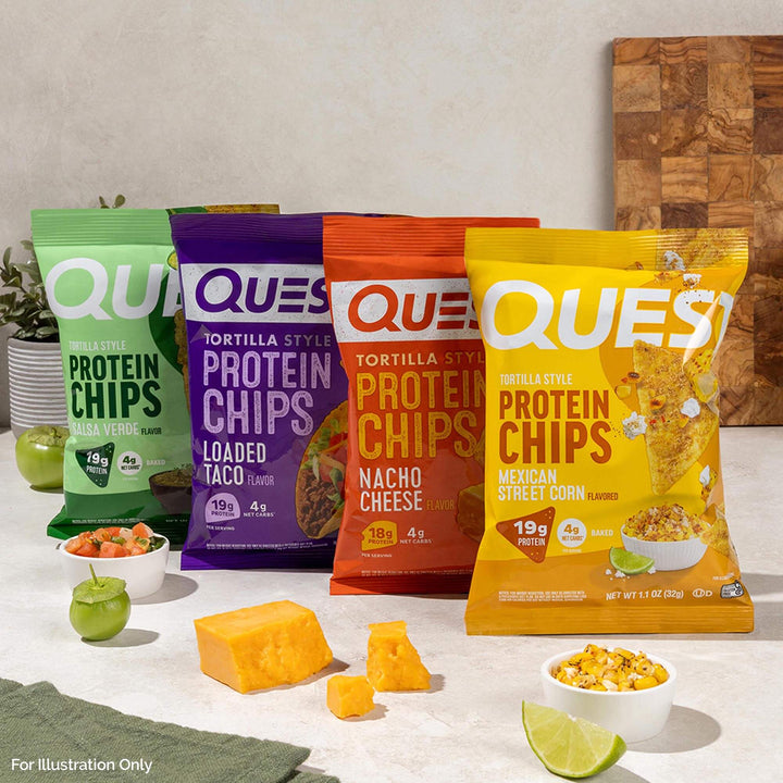 Four packages of Quest protein chips on a table with ingredients and a cutting board.