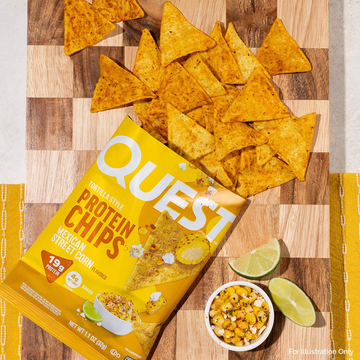Quest protein chips on a wooden cutting board with tortilla-style chips and lime wedges.