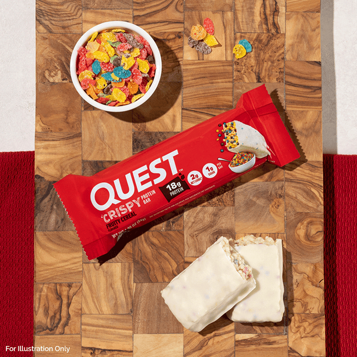 Quest Crispy protein bar on a wooden surface with cereal and a wrapped bar.