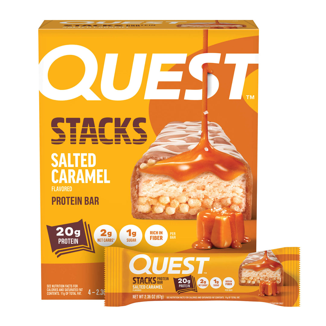 Box and wrapper of Quest Stacks Salted Caramel Protein Bar. Features caramel drizzle and nutrition highlights: 20g protein, 2g net carbs, 1g sugar.