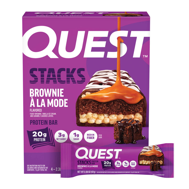 Purple box of Quest Stacks Brownie à la Mode protein bar. Image shows chocolate brownie with caramel drizzle, highlighting 20g protein and low sugar.