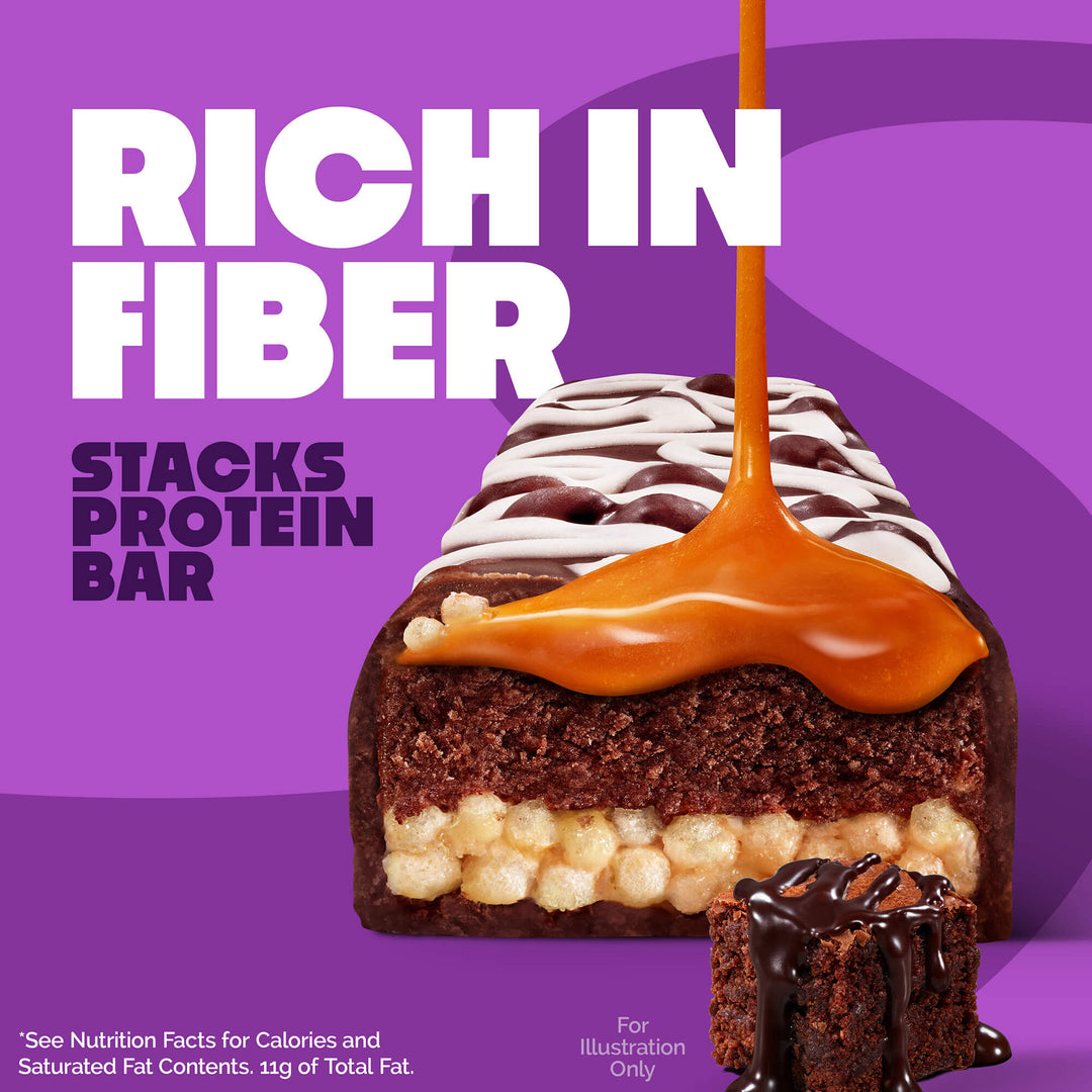 Protein bar with caramel drizzle on a purple background. Text reads "Rich in Fiber, Stacks Protein Bar." A small chocolate piece with syrup is also shown.