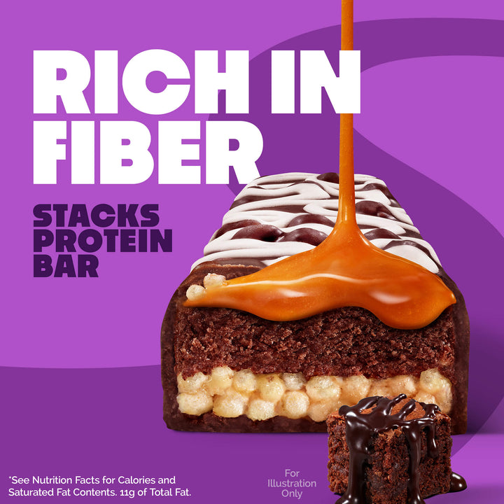 Protein bar with caramel drizzle on a purple background. Text reads "Rich in Fiber, Stacks Protein Bar." A small chocolate piece with syrup is also shown.